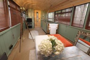 a room with a table with flowers on it at The Bus In The Woods in Belturbet