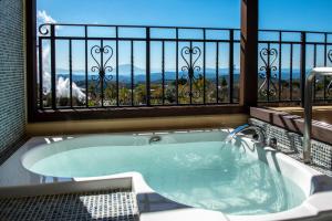 a jacuzzi tub in a room with a window at La Vista Kirishima Hills in Kirishima