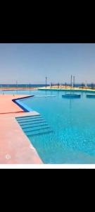 a large swimming pool with blue water in it at مرسي مطروح in Marsa Matruh