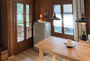 a dining room with a table and a refrigerator at Chalet Oasis - Swiss Ski Retreat in Bürglen +20 photos