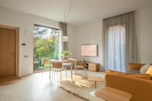 a living room with a table and a couch at 50 meters to the Sea in Juodkrantė