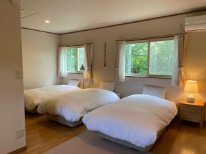 Postel nebo postele na pokoji v ubytování Mimos Cottage