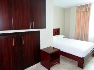 Voodi või voodid majutusasutuse Hotel Marvento Suites toas