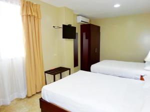 Voodi või voodid majutusasutuse Hotel Marvento Suites toas