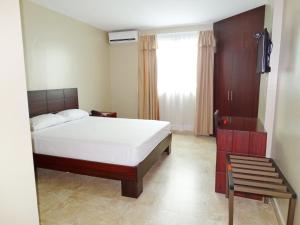 Voodi või voodid majutusasutuse Hotel Marvento Suites toas