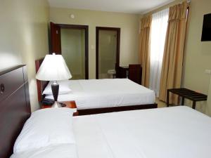 Voodi või voodid majutusasutuse Hotel Marvento Suites toas