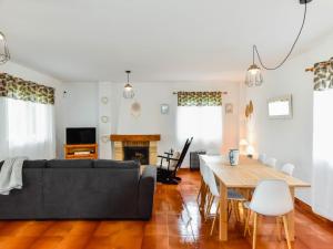 a living room with a couch and a table at Espectacular casa con piscina y gran jardín in Navajeda