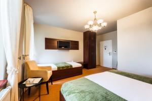 Posteľ alebo postele v izbe v ubytovaní Hotel Plumlov