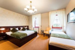 Posteľ alebo postele v izbe v ubytovaní Hotel Plumlov