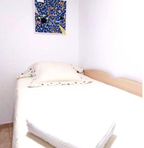 a bed in a room with a picture on the wall at Warm apartment - Lleida in Lleida +2 photos