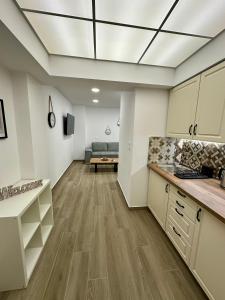 a large kitchen with a couch in a room at Academy's Modern Apartments By Aesthetic & Luxurious Living in Athens