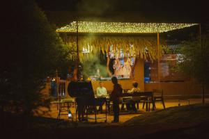 a group of people sitting at a table at night at Yakaduru - Yala in Yala