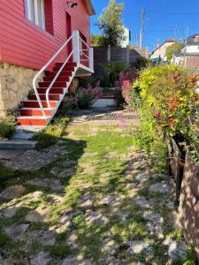 a red house with stairs on the side of it at La Maison Rouge in Trouville-sur-Mer