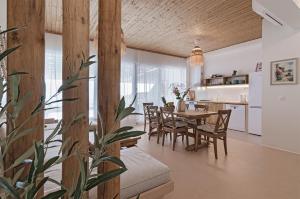 a dining room and kitchen with a table and chairs at Villa Kalimera in Balchik