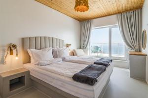 a bedroom with a large bed with a large window at Villa Kalimera in Balchik +94 photos