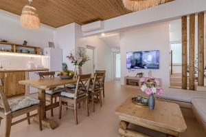 a dining room and living room with a table and chairs at Villa Kalimera in Balchik