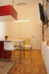 a dining room with a table and chairs and a tv at Baixa Cosy in Lisbon
