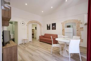 a living room with a table and a couch at La Dimora del Sole Pugliese in Casamassima