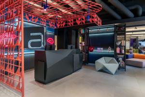 a showroom with a red ceiling and a stage at Aloft Hotel Dijon By Marriott in Dijon