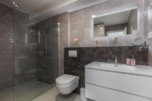 a bathroom with a toilet and a sink and a shower at Spacious Pool Apartment Crikvenica - Happy Rentals in Crikvenica