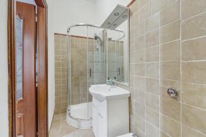 a bathroom with a toilet and a sink and a shower at Casa rustica in Gonnesa +12 photos