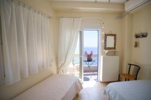 a bedroom with two beds and a view of the ocean at thalassa home in Nikiana