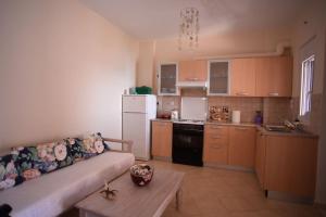 a living room with a couch and a kitchen at thalassa home in Nikiana +17 photos