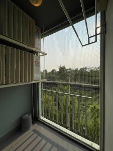 a room with a large window and a balcony at AnnaHome122@Latkrabang in Ban Khlong Prawet