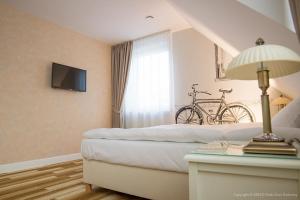 a bedroom with a bed with a bike on the wall at Serce in Sokółka