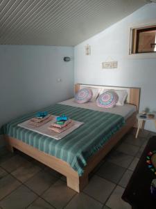 a bedroom with a bed with two towels on it at Amfialos in Skala Kallirakhis