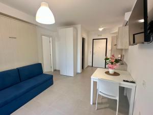 a living room with a blue couch and a table at La Maison de Marcelle in Tropea