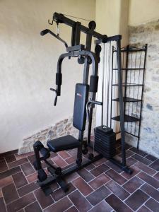 a gym with a treadmill and a chair in a room at Villino Giulio in Duddova