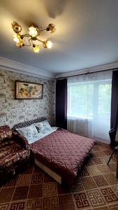 a bedroom with a large bed and a window at 2 bedroom apartment metro Vasilkovskaya Institut Raka in Kyiv