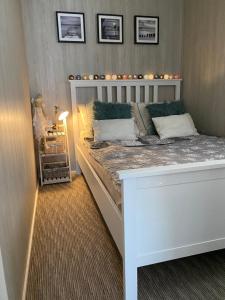 - une chambre dotée d'un lit avec un cadre blanc dans l'établissement Bujając w obłokach domek nr 22, à Gąski