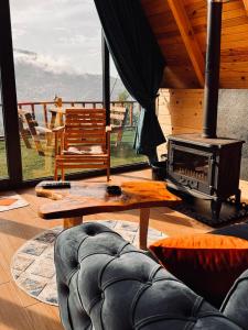 a living room with a stove and a couch at Dvabi Suit Bungalov in Çamlıhemşin +9 photos