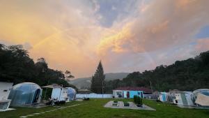a rainbow in the sky over a group of tents at The Starry Dome Family Room 2A 2K in Cameron Highlands +29 photos