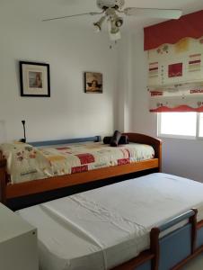 une chambre avec deux lits et un ventilateur de plafond dans l'établissement casa con terraza privada, à Nerja