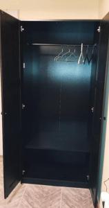 a black closet with a black door and hangers at Grb City Center - Apartment Belgrade in Belgrade