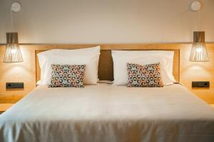 a bedroom with a large bed with two pillows at htop Amatista #htopBliss in Lloret de Mar