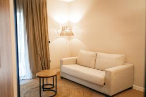 a living room with a chair and a lamp at htop Amatista #htopBliss in Lloret de Mar
