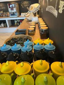 a counter with many different colored pots and pans at Skopelos Holidays Hotel & Spa in Skopelos Town