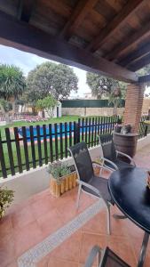 a patio with a table and chairs and a fence at Casa Albarracín in Setenil +37 photos