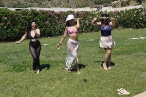 three women in costumes standing in the grass at Baglio Dello Zingaro in Scopello