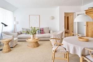 a living room with a couch and a table and chairs at Vier Häuser in Norderney