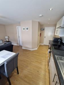 a kitchen with a counter top and a wooden floor at 4b Smart Apartments in Newark-on-Trent