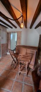 a wooden table and bench in a room at El Balcón de Valles in Reocín