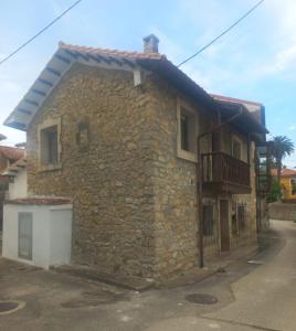 a stone house with a balcony on the side of it at El Balcón de Valles in Reocín +19 photos