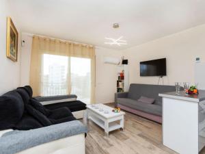 a living room with a couch and a tv at Apartment Apartamento la Moselle by Interhome in Miami Platja