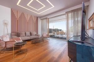 a living room with a couch and a tv at Villa Olea ZadarVillas in Petrcane +40 photos