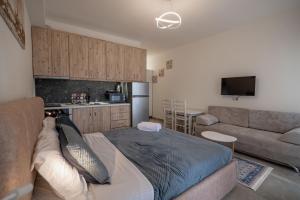 a living room with a bed and a couch at Esel Apartments in Sarandë